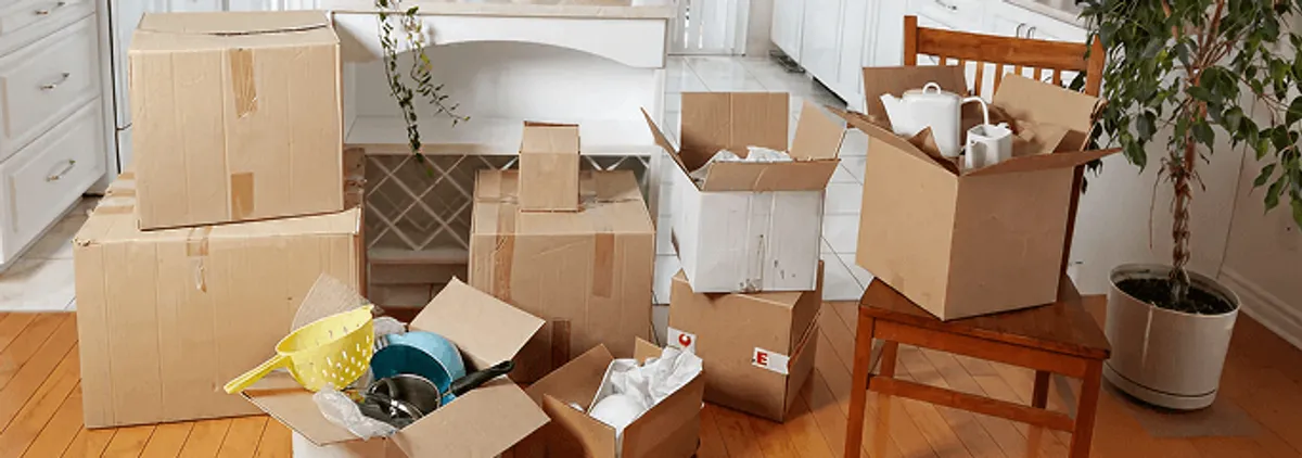 Packed moving boxes and household items in a kitchen before move-out or move-in cleaning, Boca Raton, FL.